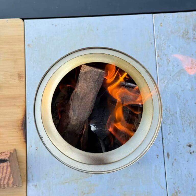 Double wall fire pit design explained with a top view of burning hardwood inside a double-wall smokeless fire pit.