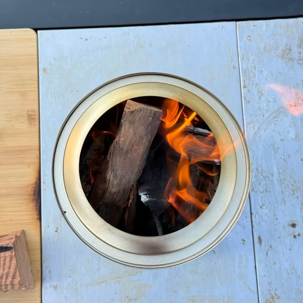Double wall fire pit design explained with a top view of burning hardwood inside a double-wall smokeless fire pit.